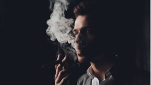 handome man in suit smoking a cigar picture id615398348 1